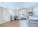 Bright living room with hardwood floors, neutral paint, and ample natural light from the windows at 31349 Philmar Ln, Wesley Chapel, FL 33543