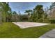A sand volleyball court surrounded by trees, perfect for outdoor recreation and friendly matches at 31349 Philmar Ln, Wesley Chapel, FL 33543