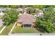 Overhead view of a home's roof, backyard, and patio, surrounded by mature trees at 3824 Duke Firth St, Land O Lakes, FL 34638