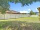 Large, fenced backyard with lush grass and mature trees, perfect for outdoor activities at 3824 Duke Firth St, Land O Lakes, FL 34638