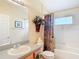 Cozy bathroom featuring a shower-tub combo and single sink vanity at 3824 Duke Firth St, Land O Lakes, FL 34638