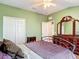 Green bedroom featuring a ceiling fan, dresser, and neutral flooring at 3824 Duke Firth St, Land O Lakes, FL 34638
