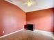 Empty bedroom with ceiling fan, terra cotta colored walls, and neutral flooring at 3824 Duke Firth St, Land O Lakes, FL 34638
