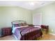 Green bedroom featuring a ceiling fan, wardrobe, and neutral flooring at 3824 Duke Firth St, Land O Lakes, FL 34638