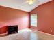Empty bedroom featuring a ceiling fan, terra cotta colored walls, and a window at 3824 Duke Firth St, Land O Lakes, FL 34638