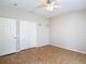 Neutral bedroom featuring a double closet, ceiling fan, and neutral flooring at 3824 Duke Firth St, Land O Lakes, FL 34638