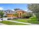 Charming single-story home featuring a well-manicured lawn, arched entryway, and a two-car garage at 3824 Duke Firth St, Land O Lakes, FL 34638
