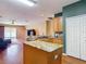 Open-concept kitchen offers an island and flows into the living area with hardwood floors at 3824 Duke Firth St, Land O Lakes, FL 34638