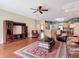 Spacious open-concept living room with hardwood floors and a view of the modern kitchen at 3824 Duke Firth St, Land O Lakes, FL 34638