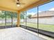 Relaxing screened-in patio with tile floors, a ceiling fan, and a view of the fenced backyard at 3824 Duke Firth St, Land O Lakes, FL 34638