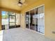 Tiled patio with ceiling fan, slider access to the house, and screen door for outdoor enjoyment at 3824 Duke Firth St, Land O Lakes, FL 34638
