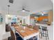 Open-concept dining area features a large table, stylish chairs, bar seating, and seamless flow into the living room at 3839 18Th N Ave, St Petersburg, FL 33713