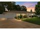 Charming single-story home with a well-maintained lawn, driveway, and attached garage at dusk at 3839 18Th N Ave, St Petersburg, FL 33713