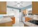A kitchen with tan cabinets, a breakfast bar, white appliances, and modern countertops at 3839 18Th N Ave, St Petersburg, FL 33713