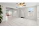 Open-concept living room featuring tile floors, neutral tones, and abundant natural light at 3839 18Th N Ave, St Petersburg, FL 33713
