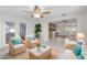 Cozy staged living room showcasing seating area and view to the kitchen and dining area at 3839 18Th N Ave, St Petersburg, FL 33713