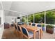 The screened patio has a wooden dining table and chairs, seating area, and lush tropical greenery views at 3839 18Th N Ave, St Petersburg, FL 33713