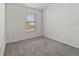 Neutral bedroom space featuring a single window and carpet at 4020 Via Sienna Cir, Sarasota, FL 34243