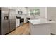 Modern kitchen featuring stainless steel appliances, white cabinetry, and quartz countertops at 4020 Via Sienna Cir, Sarasota, FL 34243