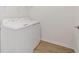 White washer and dryer set in the laundry room with wood look flooring at 4020 Via Sienna Cir, Sarasota, FL 34243