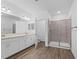 Modern bathroom featuring dual sinks, a walk-in shower, and ample cabinet space at 4020 Via Sienna Cir, Sarasota, FL 34243