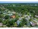 Aerial view of the neighborhood showcasing mature trees, houses, and a small lake at 4124 Herrick Ln, Sarasota, FL 34241