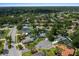 Aerial view of the neighborhood showcasing mature trees and houses with private pools at 4124 Herrick Ln, Sarasota, FL 34241
