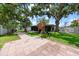 Paver patio, fenced yard, and mature trees in this lovely home's backyard with play structure at 4124 Herrick Ln, Sarasota, FL 34241