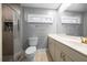 Bathroom with tile shower, toilet, and vanity with large mirror at 4124 Herrick Ln, Sarasota, FL 34241