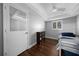A bedroom with hardwood floors, light gray walls, lots of light, and a closet door at 4124 Herrick Ln, Sarasota, FL 34241
