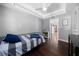 A cozy bedroom showcasing hardwood floors, light gray walls, and natural light from the windows at 4124 Herrick Ln, Sarasota, FL 34241