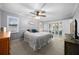 Comfortable bedroom with ceiling fan and access to a screened outdoor patio at 4124 Herrick Ln, Sarasota, FL 34241