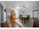 Bright dining room with hardwood floors and a view into the adjacent kitchen at 4124 Herrick Ln, Sarasota, FL 34241