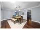 Dining room featuring modern lighting fixtures, a dining table with seating, and hardwood flooring at 4124 Herrick Ln, Sarasota, FL 34241