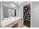 Vanity area leading to bathroom and walk-in closet with built in shelving and storage at 4124 Herrick Ln, Sarasota, FL 34241