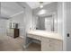 Bedroom dressing area with built-in vanity and mirror, leading to a bathroom at 4124 Herrick Ln, Sarasota, FL 34241