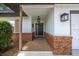 Welcoming front porch with a decorative wreath on the front door and updated exterior lighting at 4124 Herrick Ln, Sarasota, FL 34241