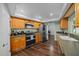 Modern kitchen with wood cabinets, stainless steel appliances, and dark wood floors at 4124 Herrick Ln, Sarasota, FL 34241