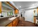 Well-lit kitchen featuring wood cabinets, stainless steel appliances, and a large window overlooking the patio at 4124 Herrick Ln, Sarasota, FL 34241