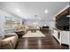 Spacious living room with hardwood floors, neutral decor, and ample natural light at 4124 Herrick Ln, Sarasota, FL 34241
