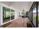 Relaxing outdoor patio space featuring brick flooring and large windows for plenty of natural light and space at 4124 Herrick Ln, Sarasota, FL 34241