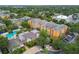 Aerial view of a colorful condo community with a pool and lush landscaping at 4207 S Dale Mabry Hwy # 2105, Tampa, FL 33611