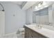 Clean bathroom featuring a stylish vanity with white marble counters, blue walls, and modern fixtures at 4207 S Dale Mabry Hwy # 2105, Tampa, FL 33611