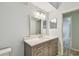 Bright bathroom with a framed mirror, gray vanity, white marble countertop, and neutral paint at 4207 S Dale Mabry Hwy # 2105, Tampa, FL 33611