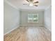 Bright bedroom featuring modern ceiling fan, wood-look flooring, and plantation shutters at 4207 S Dale Mabry Hwy # 2105, Tampa, FL 33611