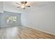 Bright bedroom featuring hardwood floors, soft blue paint, and shutters on the window for natural light at 4207 S Dale Mabry Hwy # 2105, Tampa, FL 33611