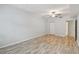 Large bedroom featuring hardwood floors, soft blue paint, with neutral trim and a ceiling fan at 4207 S Dale Mabry Hwy # 2105, Tampa, FL 33611