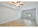 Bright bedroom featuring hardwood floors, soft blue paint, and shutters on the window for natural light at 4207 S Dale Mabry Hwy # 2105, Tampa, FL 33611