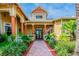Inviting community center with brick pathway, colorful pillars, and manicured landscaping at 4207 S Dale Mabry Hwy # 2105, Tampa, FL 33611