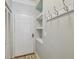 Entryway features a white door, coat hooks, a small storage nook, and wood-look floors for added functionality at 4207 S Dale Mabry Hwy # 2105, Tampa, FL 33611